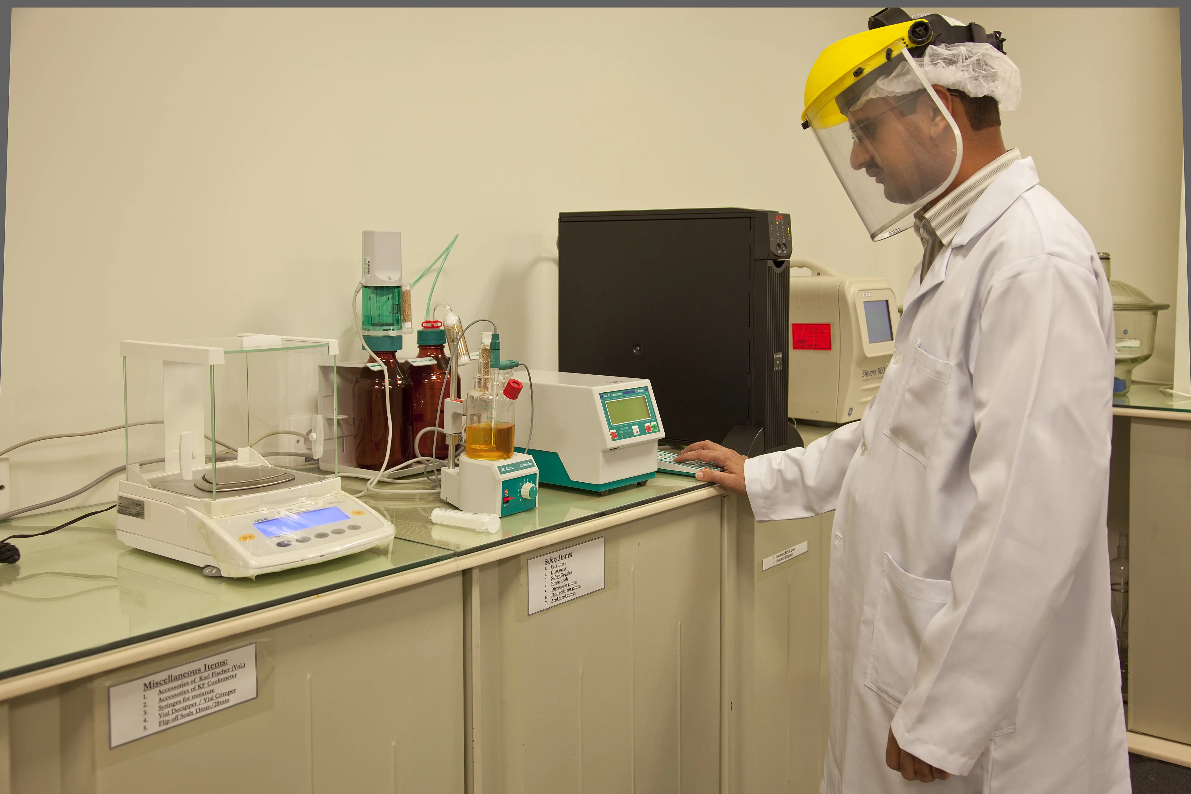 Quality control scientist operating laboratory instruments