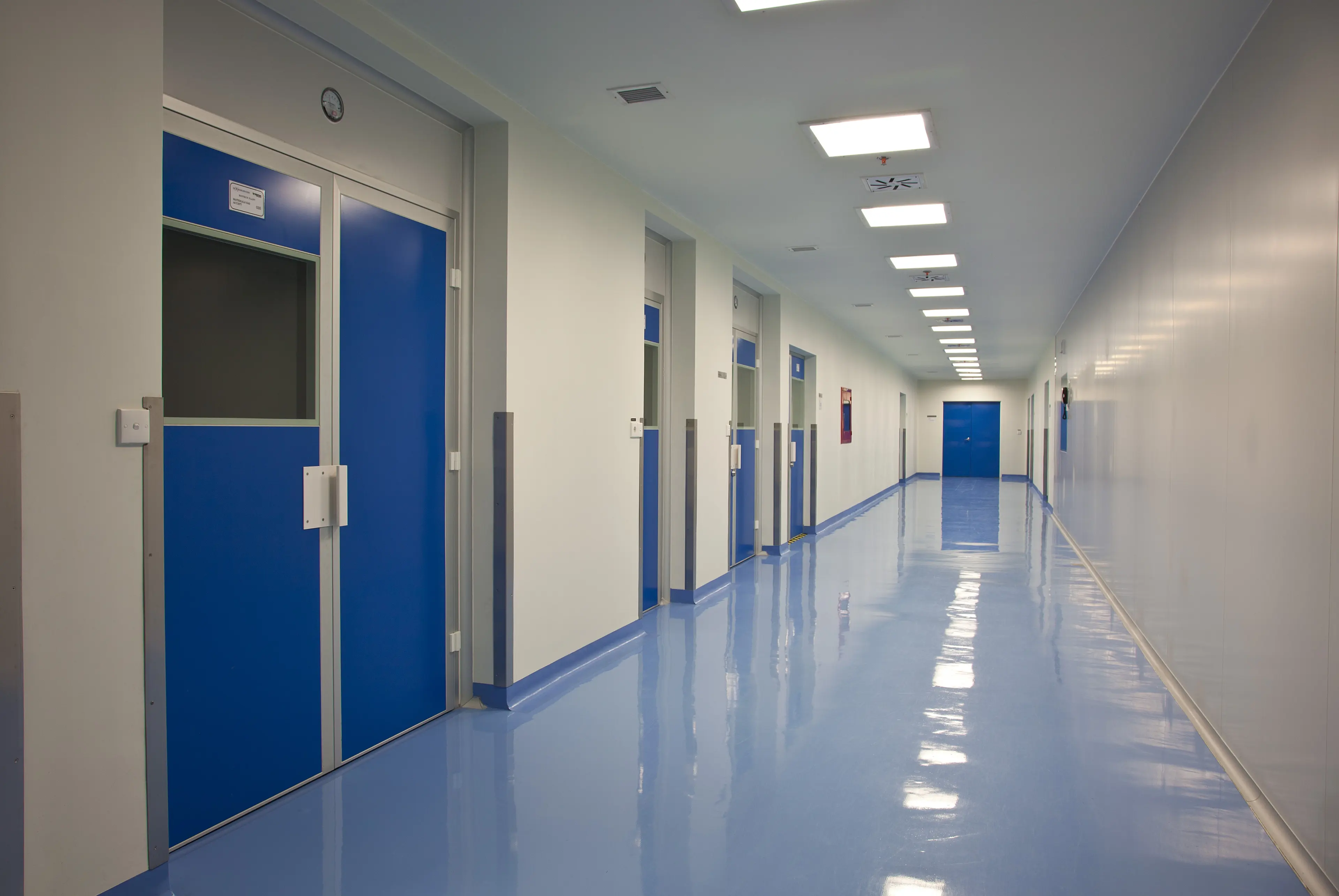 Clean classified corridor with blue personnel doors